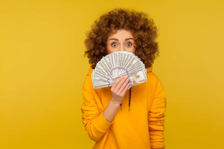 Picture of girl with money in front of her mouth